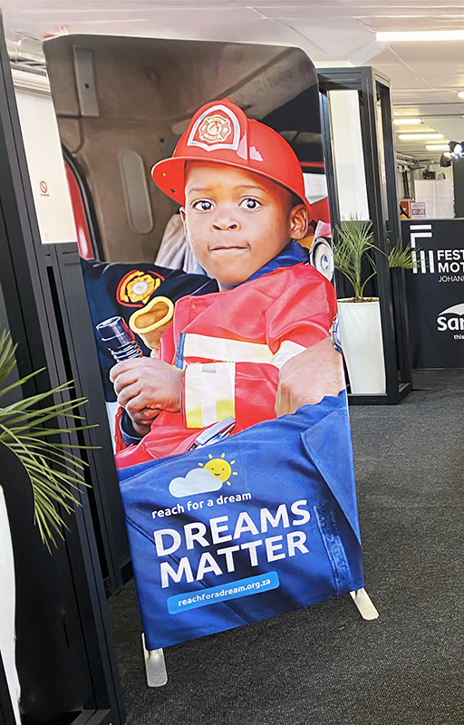 A sock-banner displayed at the Festival of Motoring at the Kyalami Racetrack, provided by Brand Monster to Reach For a Dream.