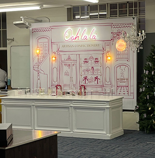 A banner wall as part of a retail display for Ooh La La Confectionary
