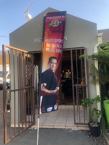 A telescopic-banner branded for Arnold Esports at an outdoor event