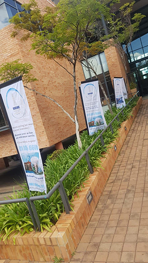 A row of telescopic banners printed at an office entrance