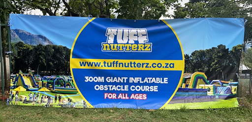 A fence banner printed for Tuff Nutterz by Brand Monster, attached to a fence.
